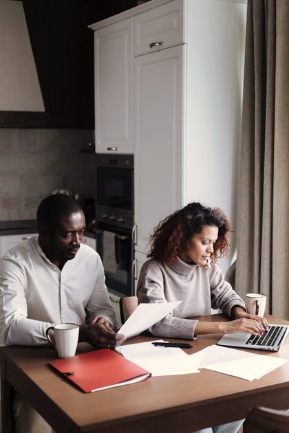 A working-age couple going over paperwork at home